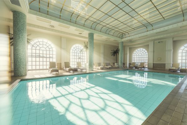 The indoor pool area at Boardwalk with light streaming in from the windows